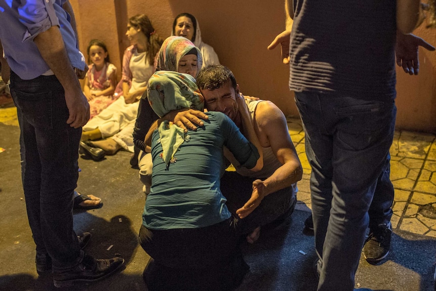 Relatives grieve at hospital following a late night militant attack on a wedding party in Turkey.