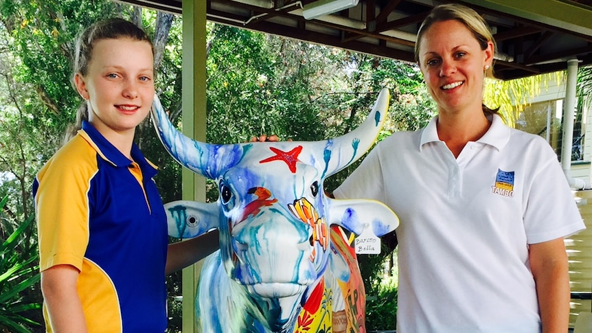 Tambo State School student Selena (left) and teacher Belinda Thompson with Barcoo Bella, one of the art project's cows.