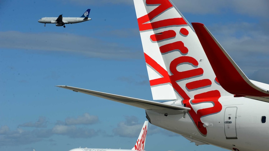 Two Virgin airplanes on the tarmac at Sydney Airport.