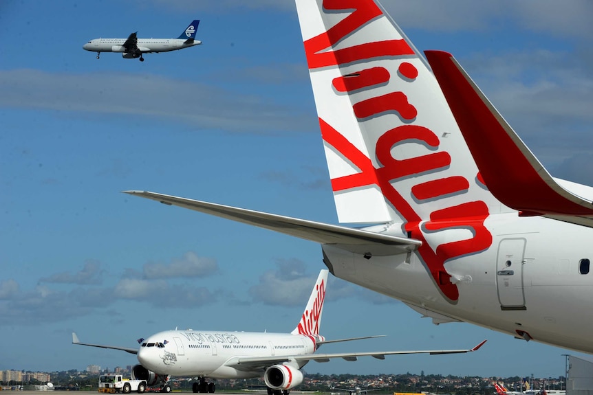 Two Virgin airplanes on the tarmac at Sydney Airport.