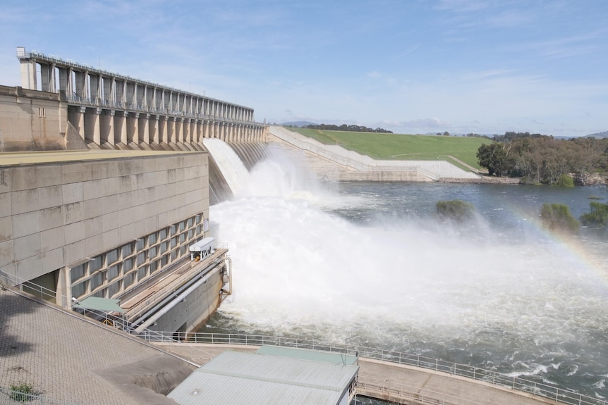 A dam wall has water being released.