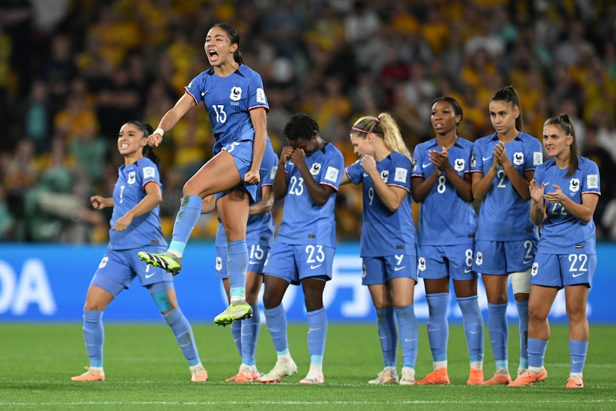 France celebrates an Australian miss in a World Cup penalty shootout.