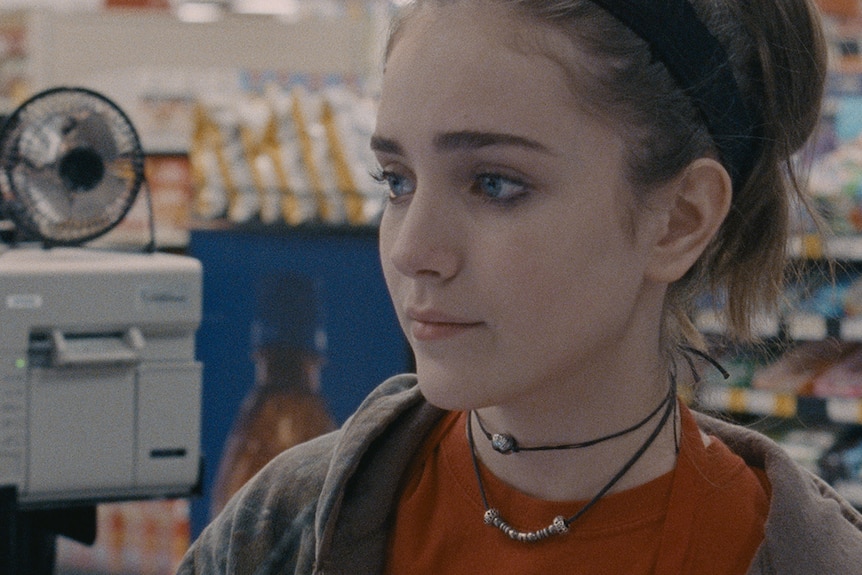 Close up of film's protagonists, Skylar (Talia Ryder) at a pharmacy or store looking at something.