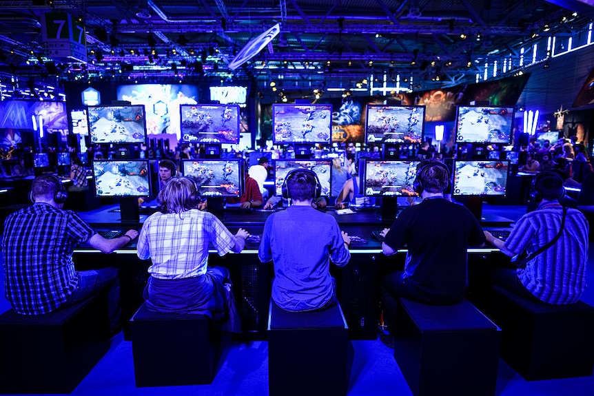 Visitors try out the role-playing game 'World Of Warcraft' at Gamescom 2015 in Cologne, Germany