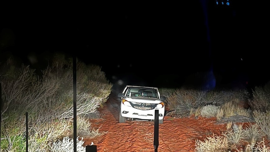 A car found bogged by police in the South Australian outback at night. 