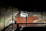 A car found bogged by police in the South Australian outback at night. 