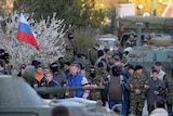 Pro-Russian militiamen cordon off as Russian soldiers storm the Ukrainian military airbase in Belbek