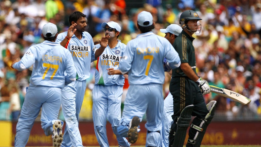 Praveen Kumar of India is congratulated