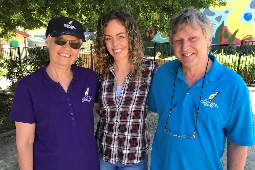 Bev and Glenn Langley stand smiling with Jess Jones standing in between them