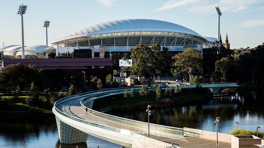 Adelaide Oval and the Torrens Footbridge shine in the evening light.