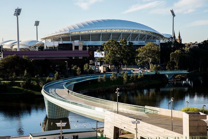 Adelaide Oval and the Torrens Footbridge shine in the evening light.