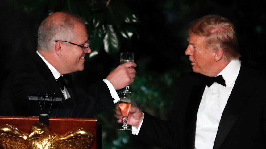 Donald Trump and Scott Morrison raise a glass to one another during the state dinner at the White House.