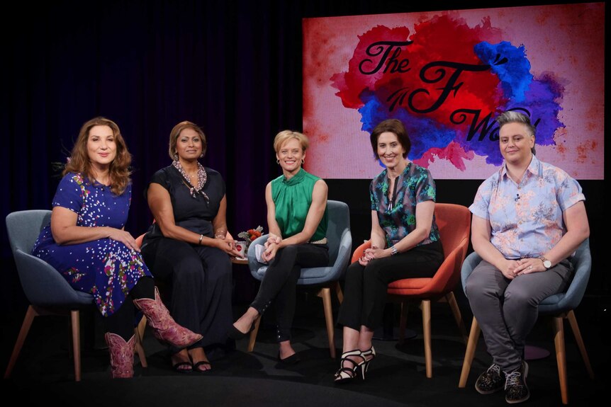 Five women sit pose for a seated photo on stage, with "The F Word" logo in the backround