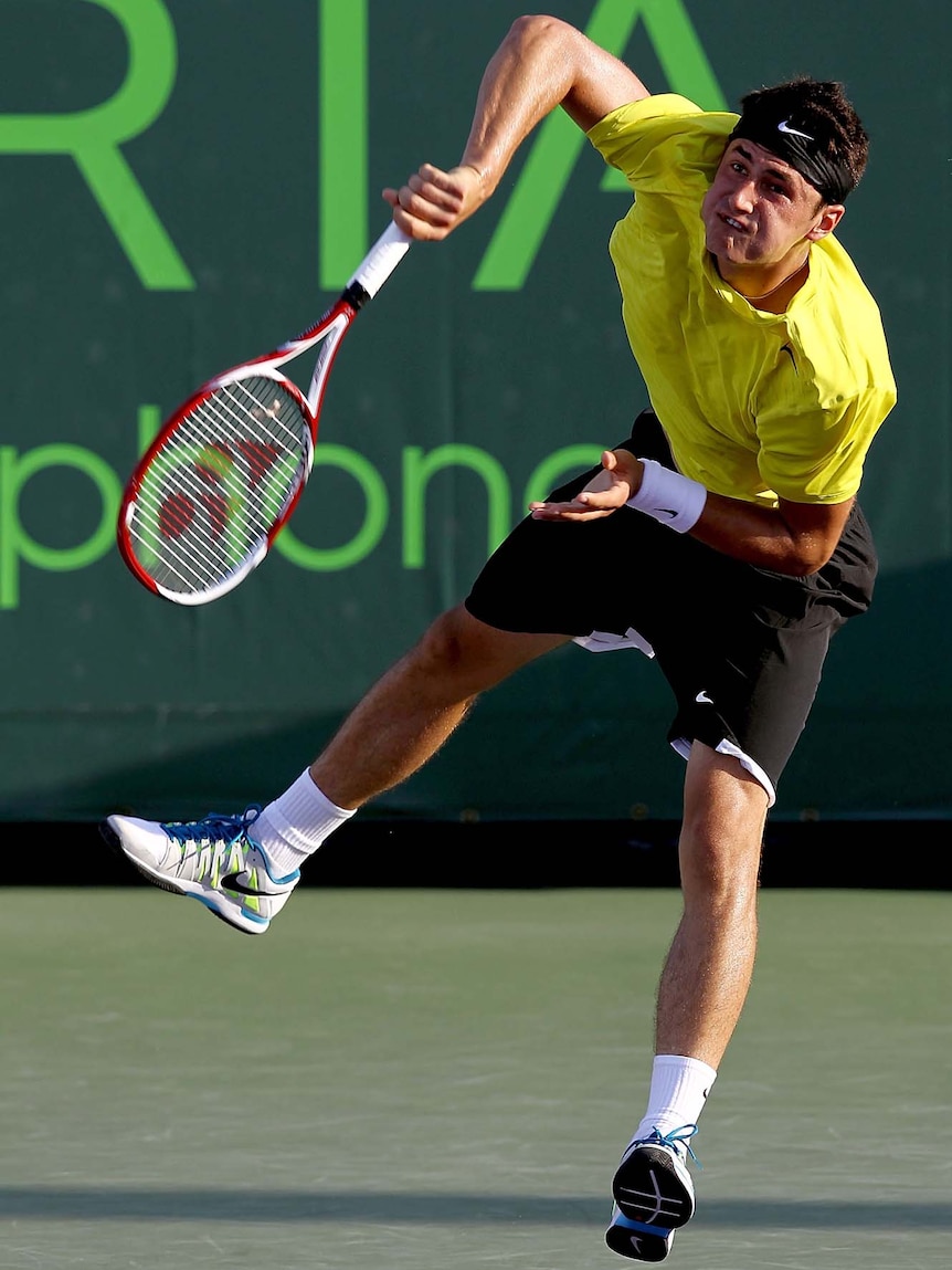 Bernard Tomic serves in the first round of the Miami hardcourt tournament