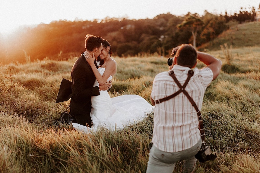 Luke Middlemiss photographs a couple at One Tree Hill in Maleny