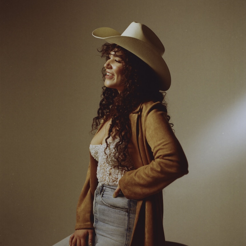Photo of Country music artist Emily Nenni in cowboy hat.