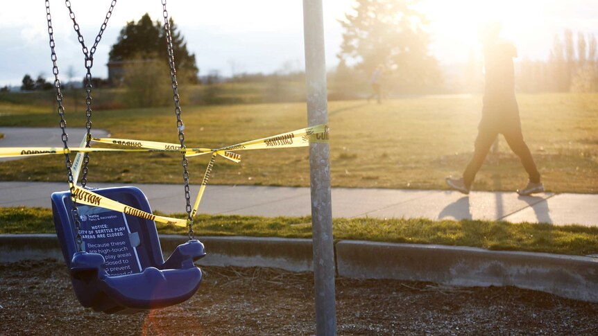 A swing at a playground wrapped up in police tape