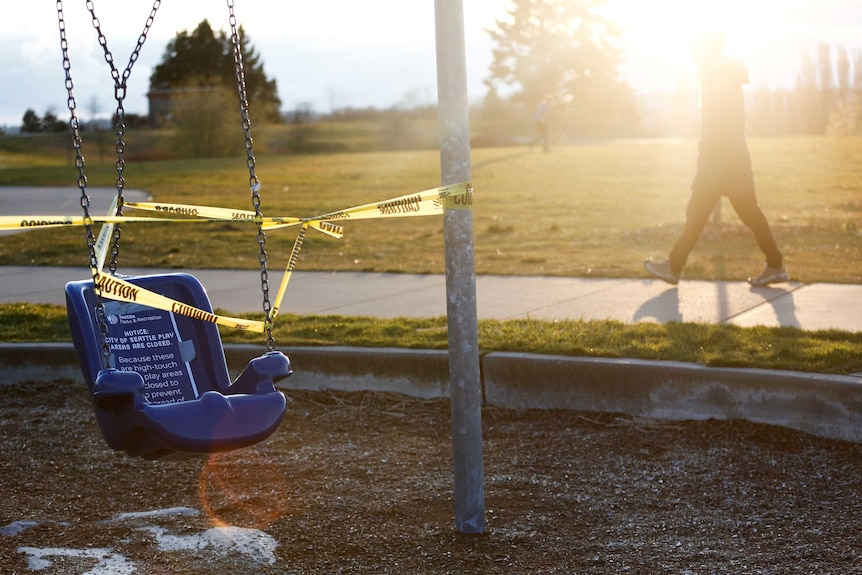 A swing at a playground wrapped up in police tape