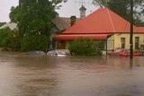 Cars and homes submerged in floodwaters in Dungog, NSW.
