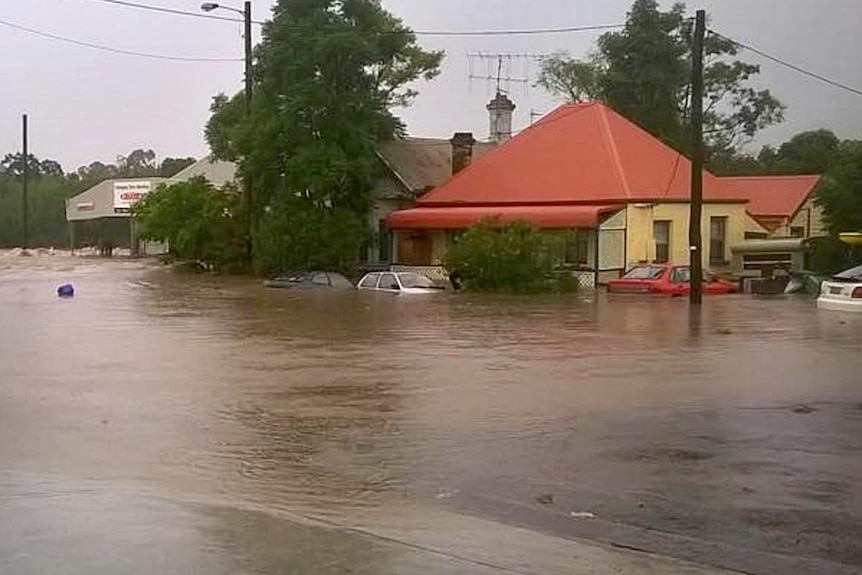 Cars and homes submerged in floodwaters in Dungog, NSW.