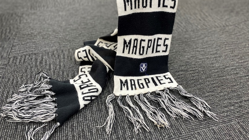 A black and white Collingwood Magpies AFL supporter scarf