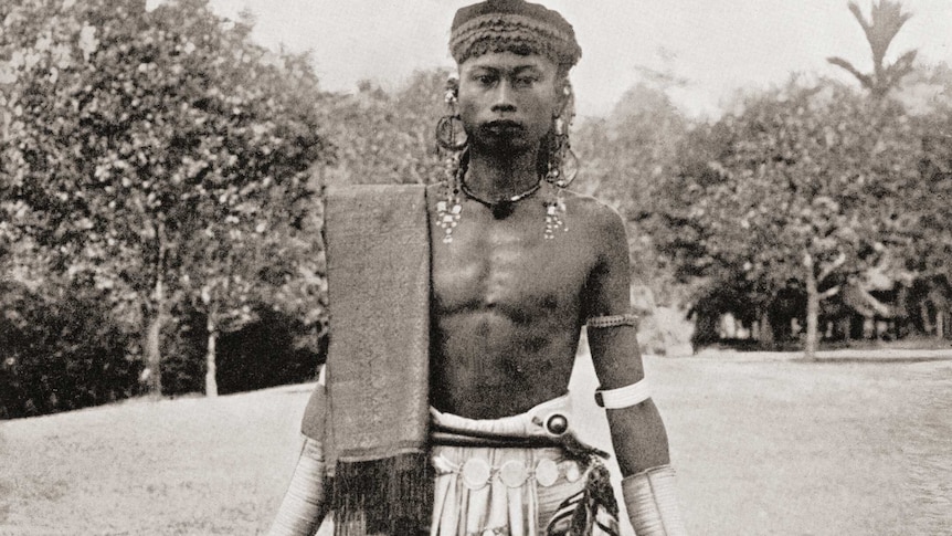 Photo from 1913 of indigenous Dayak from Borneo pictured with two human heads - a practice carried out with great reverence.