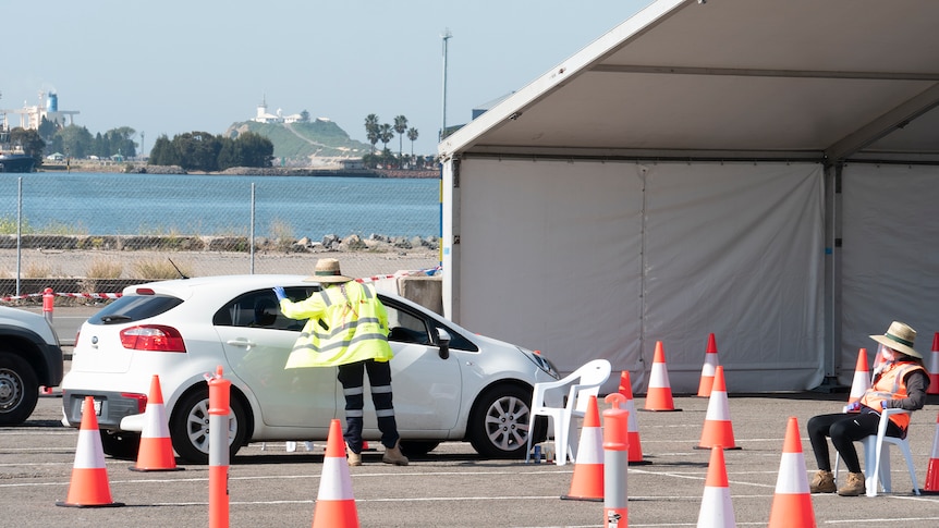 Open air COVID testing clinic with a car about to go through