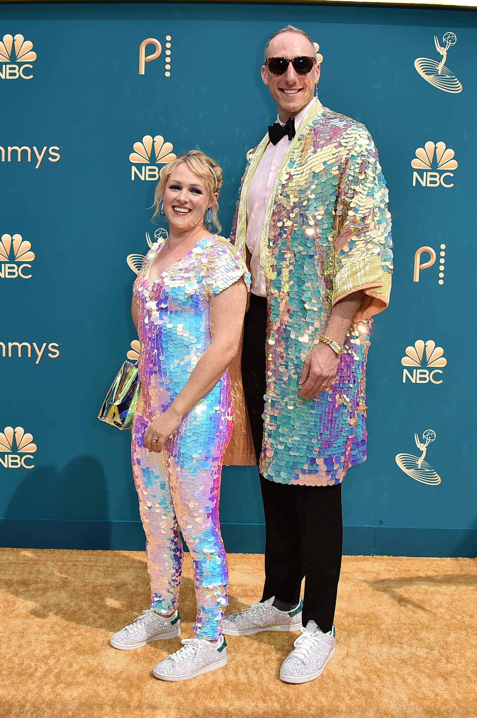 Ariel Dumas and Andrew Ecker wearing sequined suits and shimmery sneakers