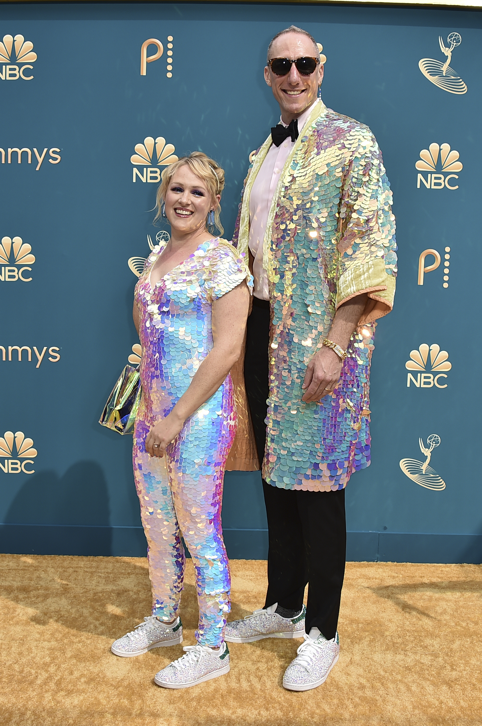 Ariel Dumas and Andrew Ecker wearing sequined suits and shimmery sneakers