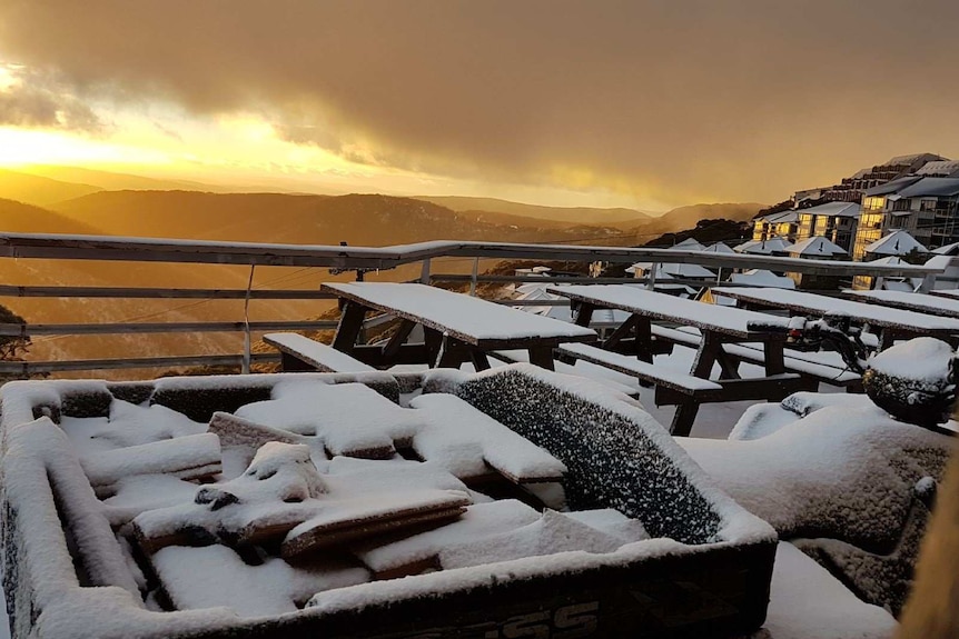 Sunrise at Mount Hotham shows snow on cafe tables