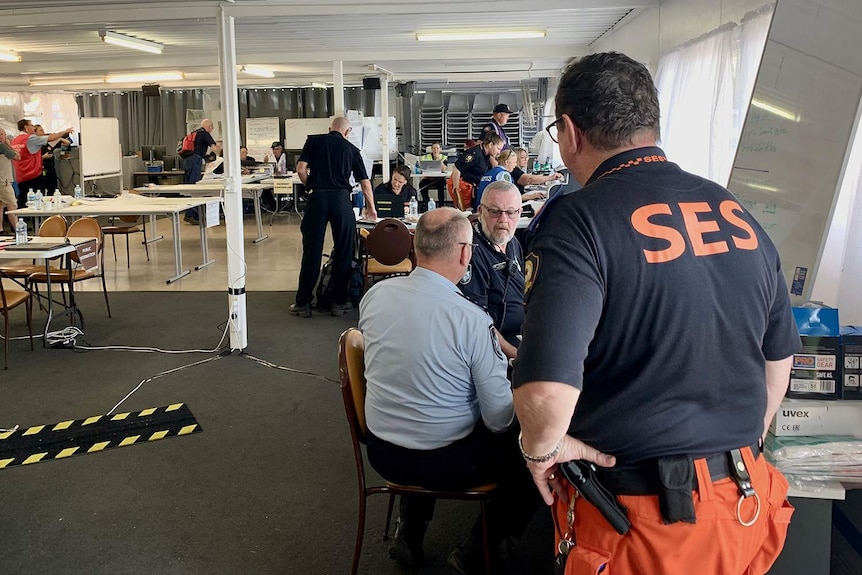 Staff work inside the Incident Control Centre set up at the Boonah Showgrounds.