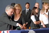 Private Greg Sher's parents pay their respects.