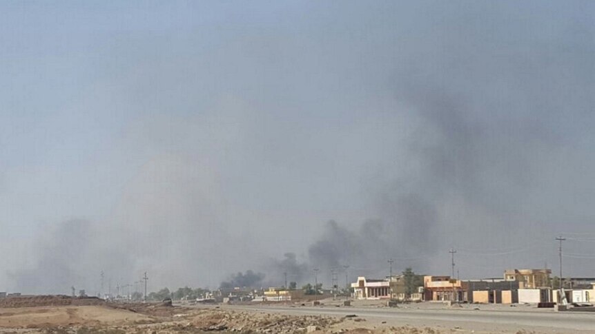 Smoke rises over Karama district in Mosul where Iraqi troops are fighting Islamic State.