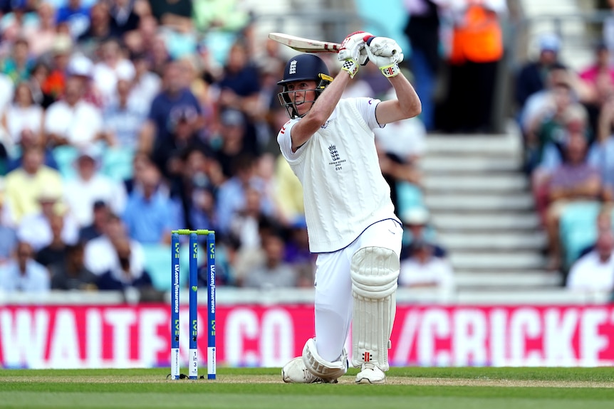 England batter Zak Crawley ends with his bat above his head after playing a shot during an Ashes Test.