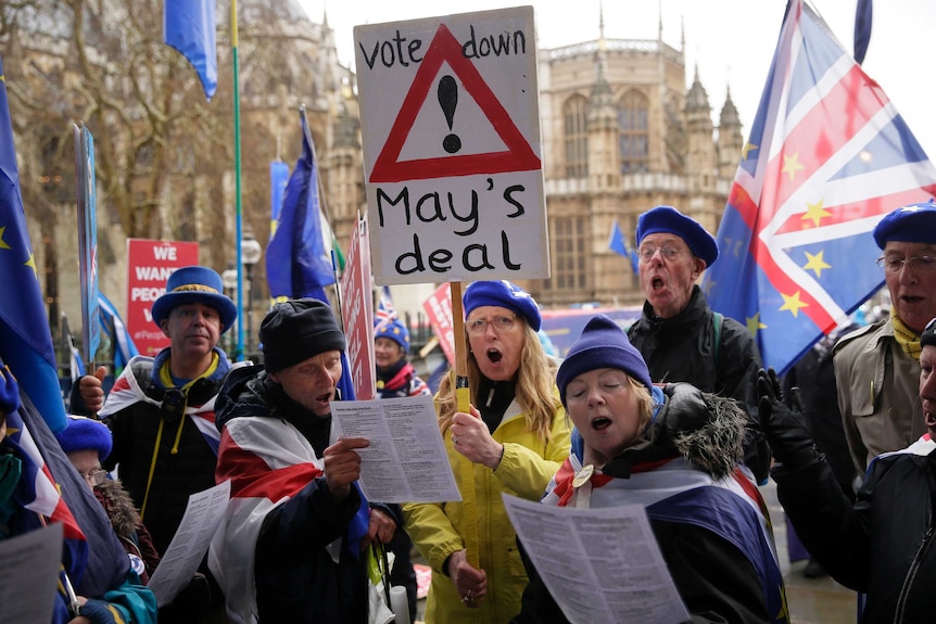 Anti-Brexit voters holding placards and singing outside the House of Parliament in London.