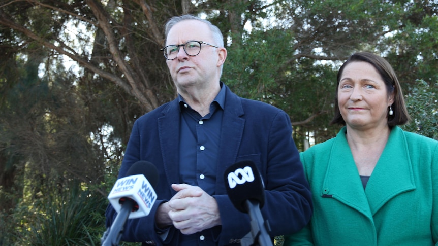 Man stands in front of mic with a woman