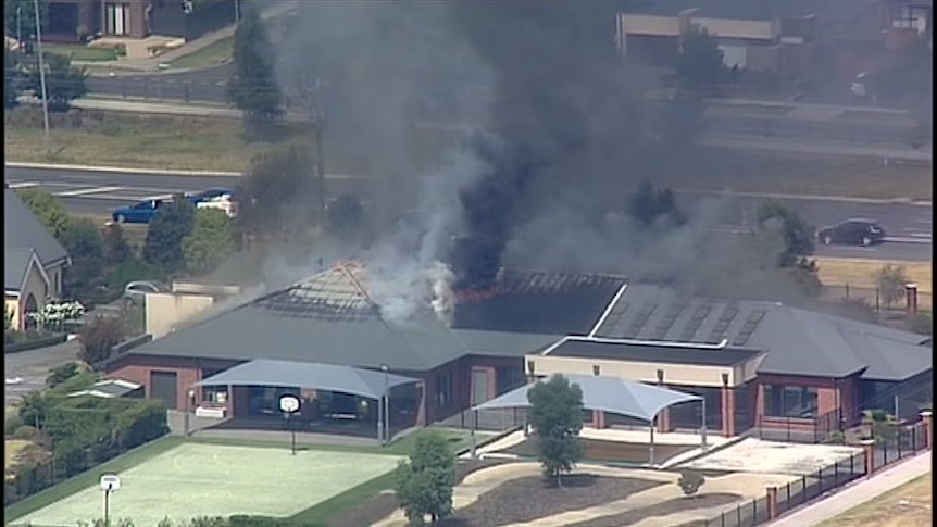 Aerials image of smoke billowing from the roof of a Cranbourne East retirement home.