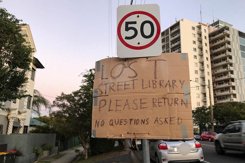 The sign for help placed on a speed sign in Highgate Hill.