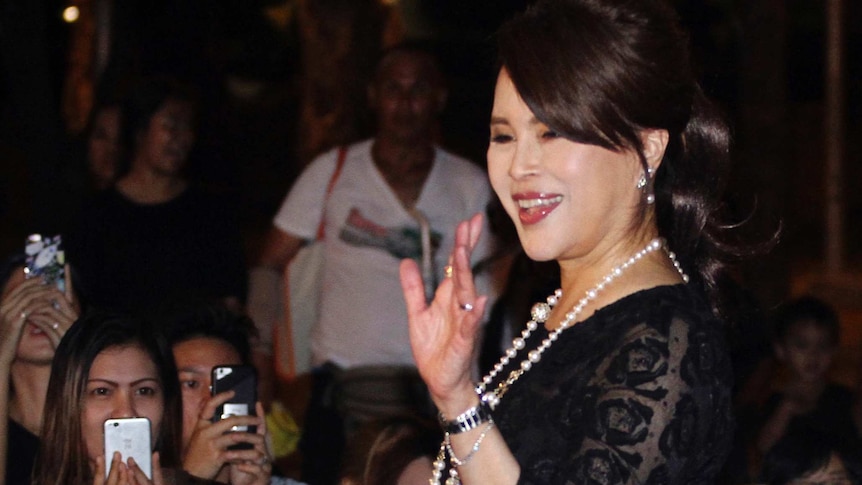 Thai Princess Ubolratana Mahidol wearing a black lace dress and pearls waves to Thai people outside Grand Palace in Bangkok.