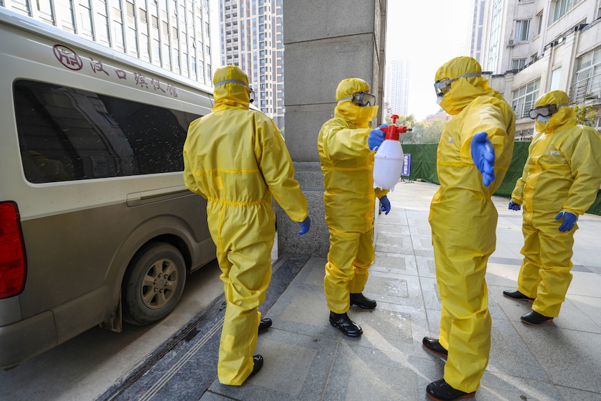 Funeral parlour staff wear protective suits following coronavirus outbreak