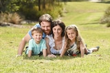 Lung cancer patient Lisa Briggs lies on the grass with her young family