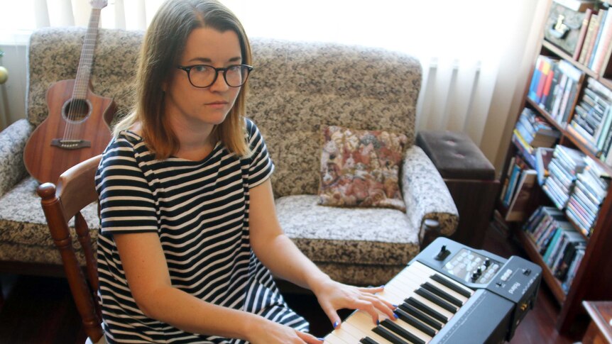 Perth soprano Bri Louwen sits at her keyboard.