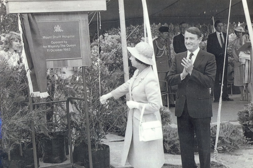 A lady in white and a man in a suit