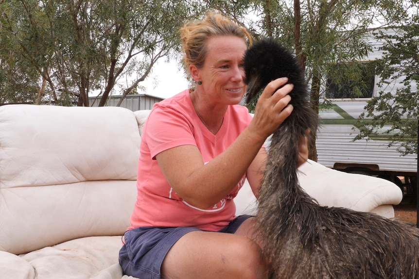 Silverton woman Petah Devine and her new baby emu, Totto.