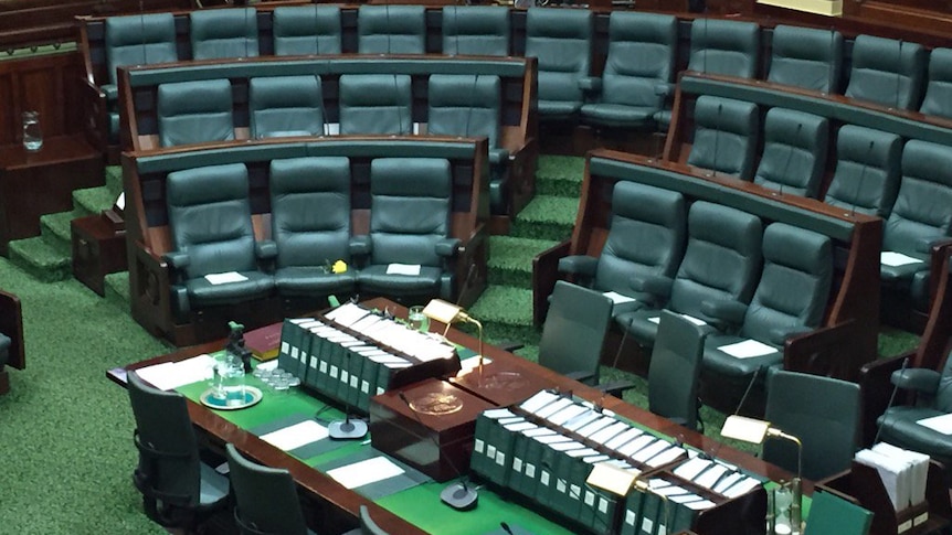 A yellow rose is left in Fiona Richardson's seat in Victorian Parliament