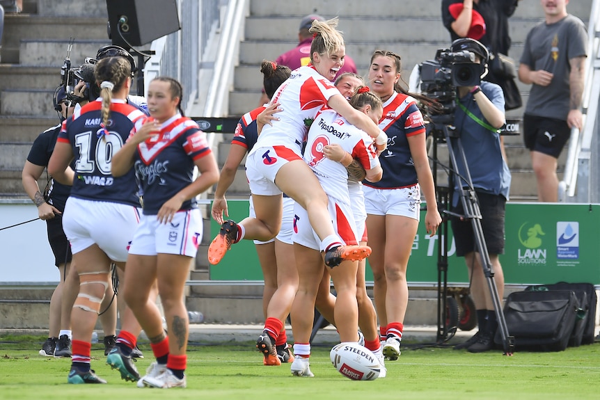 Sydney players look disappointed as Madison Bartlett's St George teammates jump on her