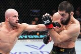 Alexander Volkanovski of Australia punches Islam Makhachev of Russia in the UFC lightweight championship fight.
