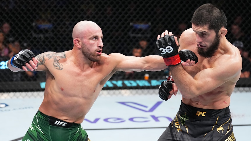 Alexander Volkanovski of Australia punches Islam Makhachev of Russia in the UFC lightweight championship fight.