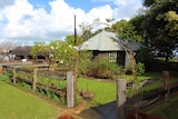 Small jarrah church surrounded by greenery