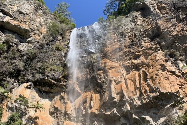 A photograph from below a waterfall in an Australian national park.